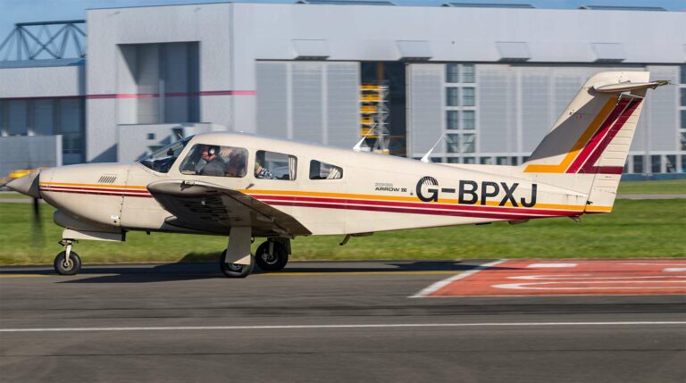 Small plane with registration G-BPXJ taxiing on runway