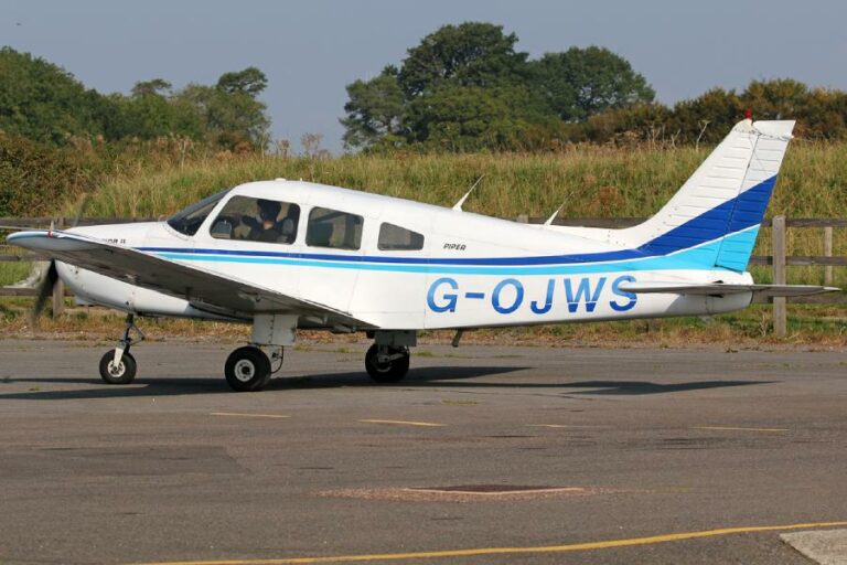 Small Piper aircraft with registration G-OJWS on runway