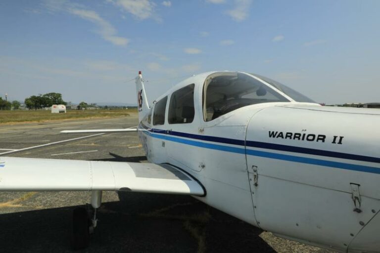 Warrior II small airplane parked on airstrip