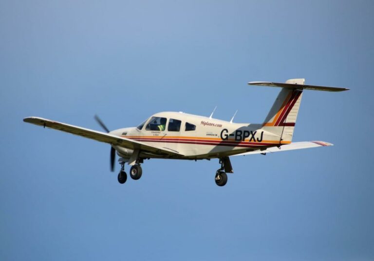 Single-engine plane flying against clear blue sky