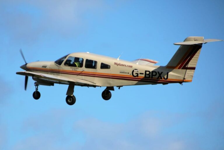 Small aircraft flying against a blue sky