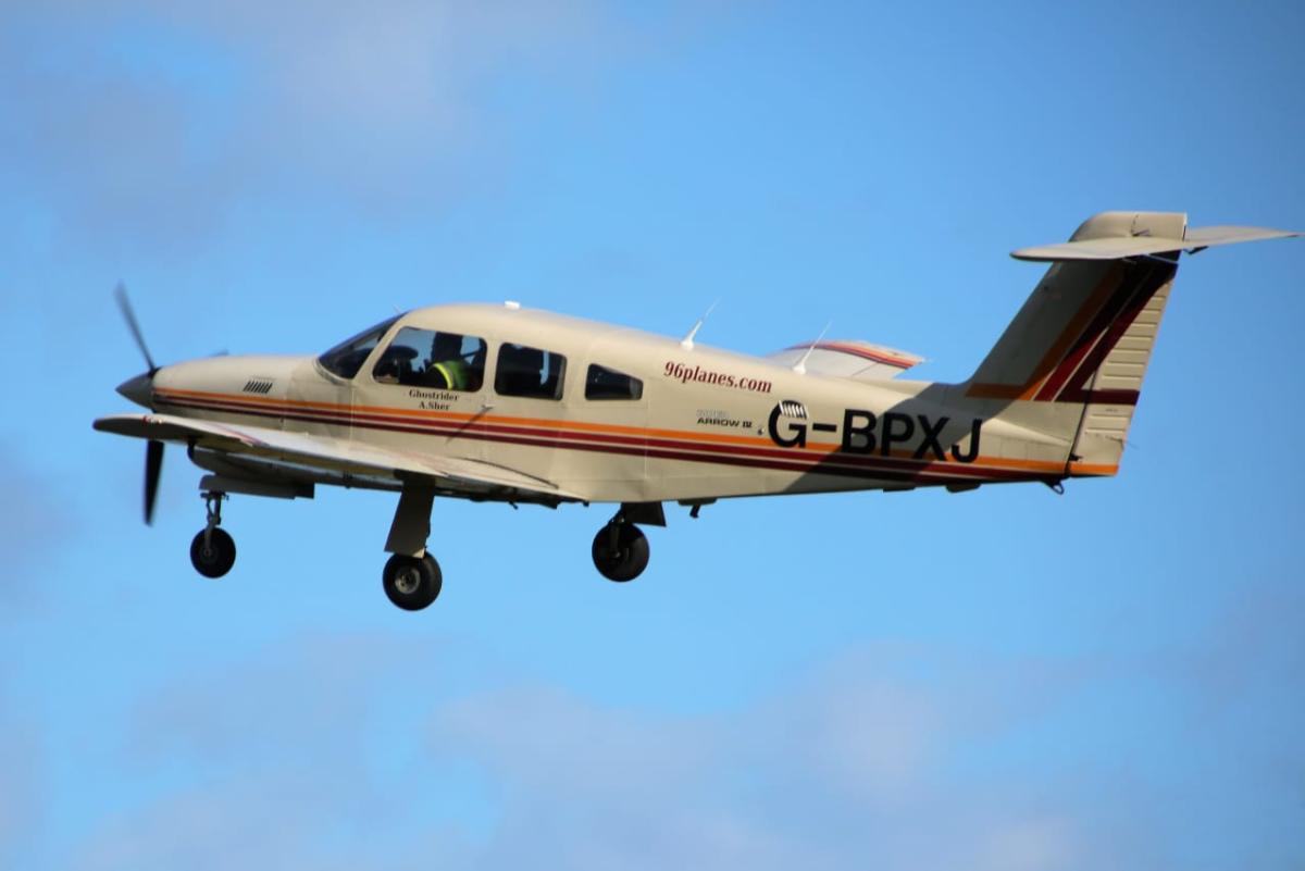 Small aircraft flying against a blue sky