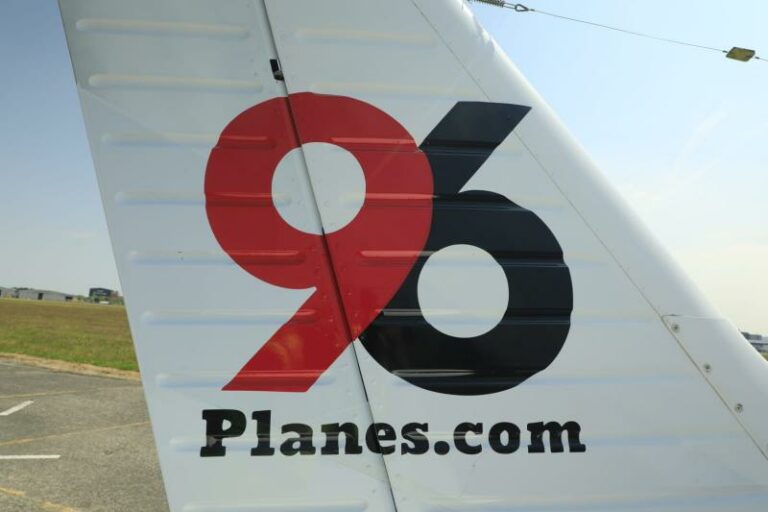 Tail of aircraft with 'Planes.com' and number 96.
