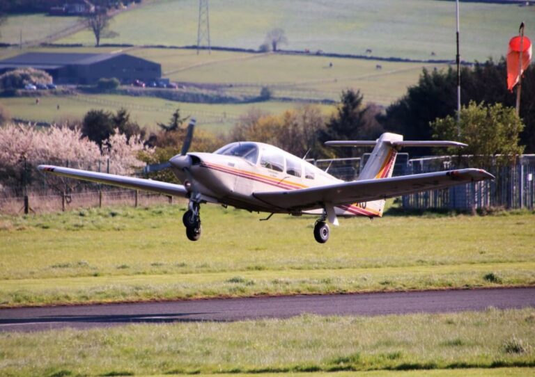 Small aircraft landing on rural airstrip