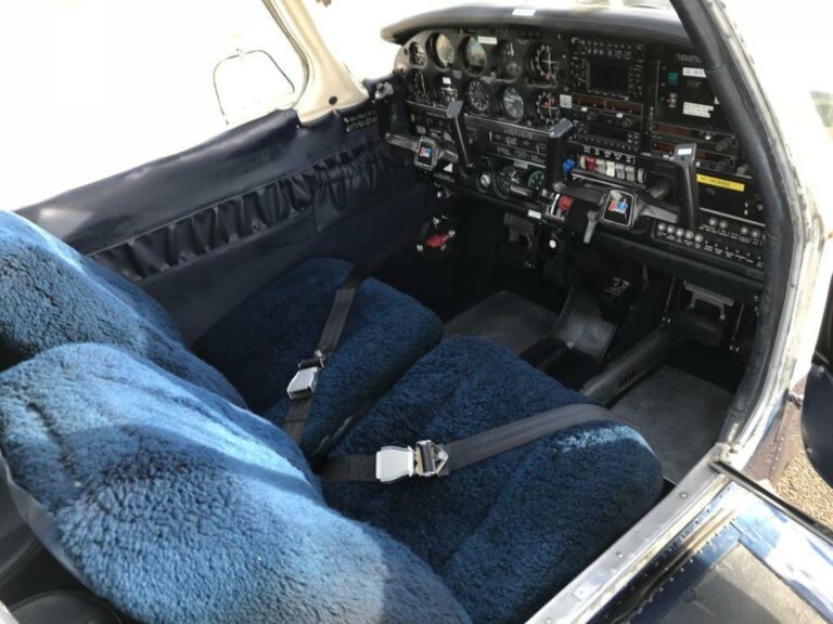 Detailed cockpit view of vintage airplane with blue seats