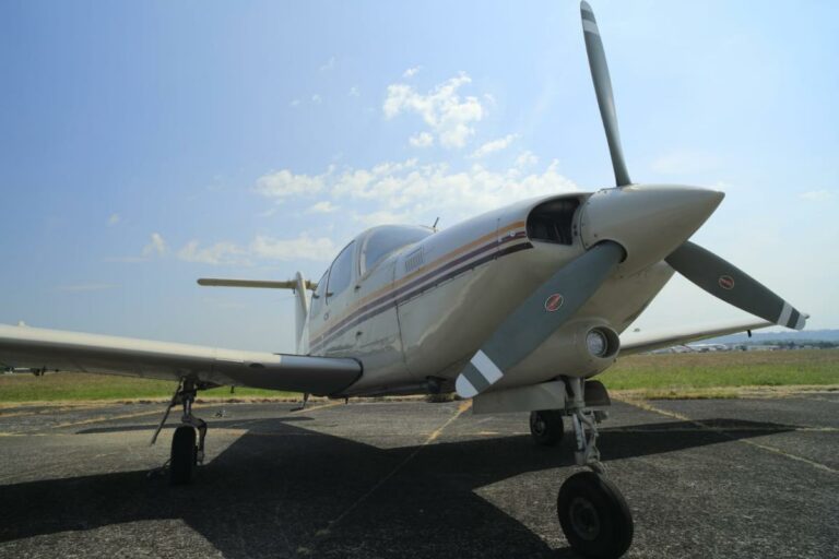 Small aircraft parked on sunny tarmac