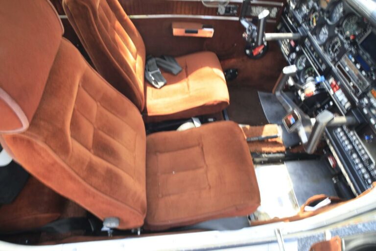 Vintage aircraft cockpit with plush orange seats