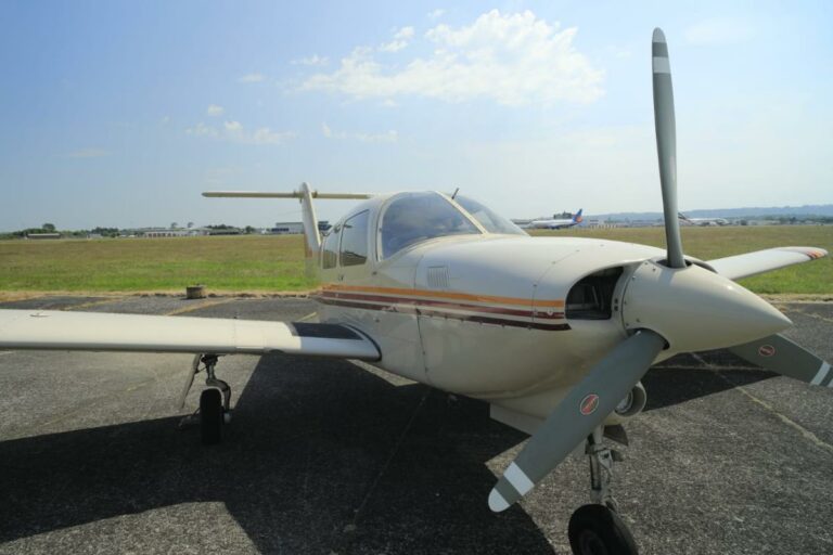 Light aircraft parked on sunny airstrip