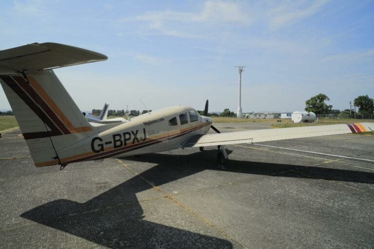 Small plane G-BPXJ on sunny airstrip