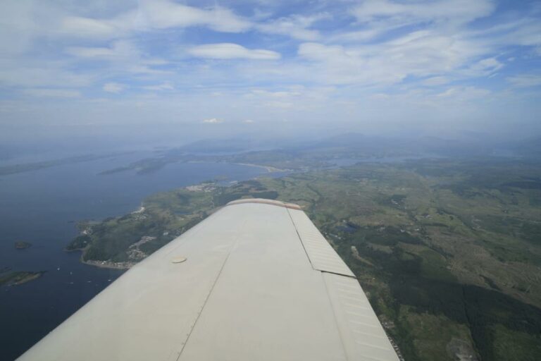 Aerial view from airplane wing over scenic landscape
