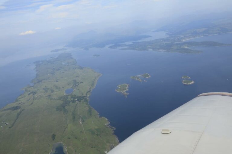 Aerial view of coastal land from airplane wing