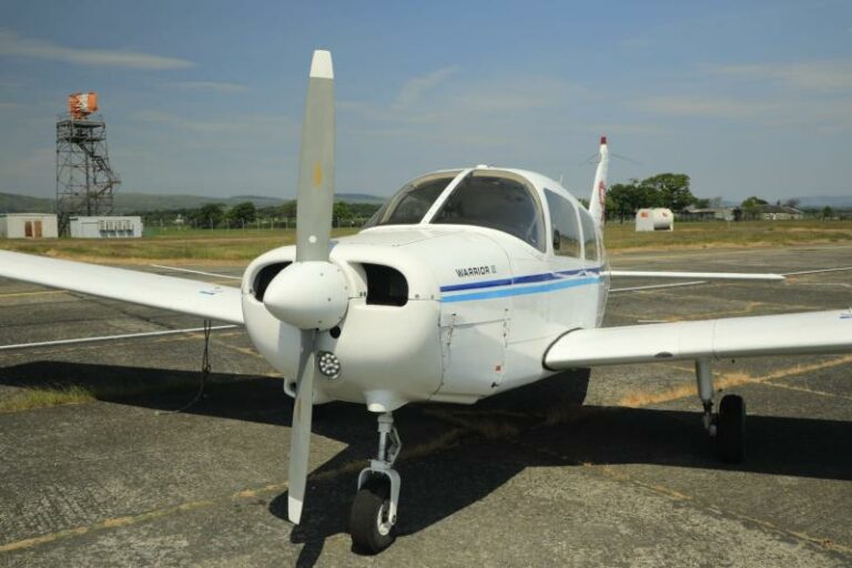 Small airplane parked on sunny airport tarmac