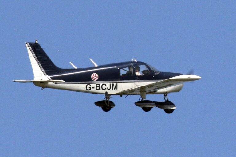 Small plane flying against clear blue sky