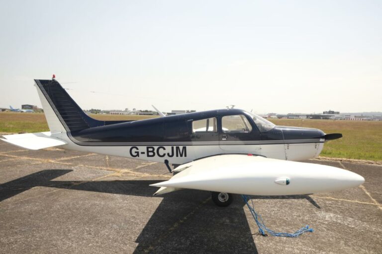 Piper PA-28 Cherokee aircraft parked on sunny tarmac