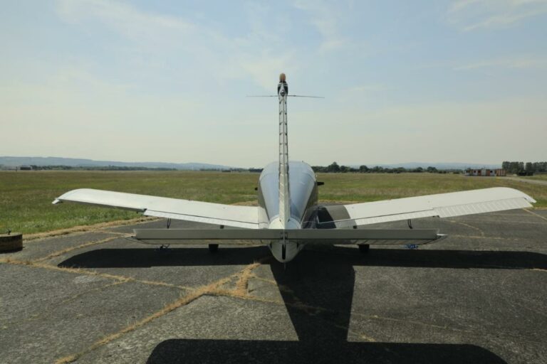 Single-engine plane parked on small airstrip