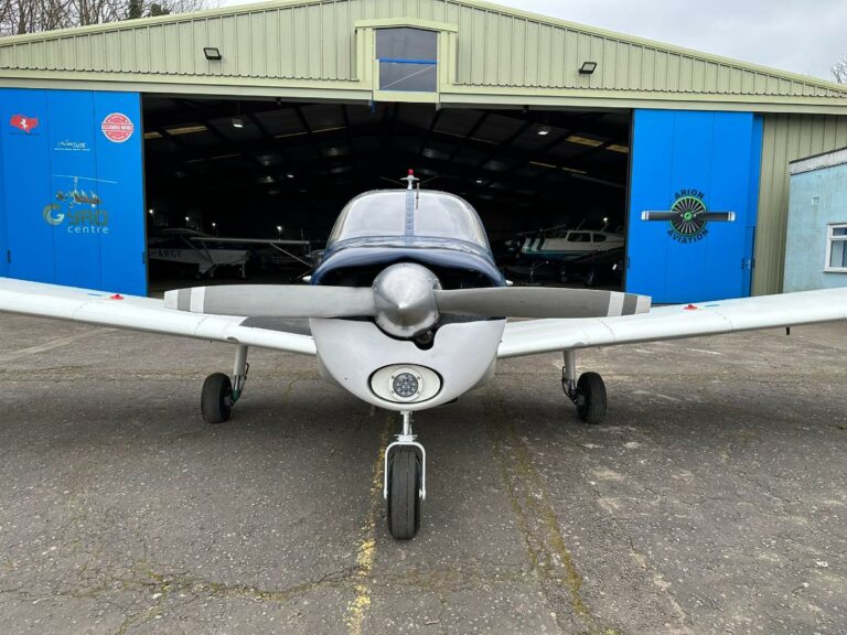 Small aircraft parked in front of aviation centre
