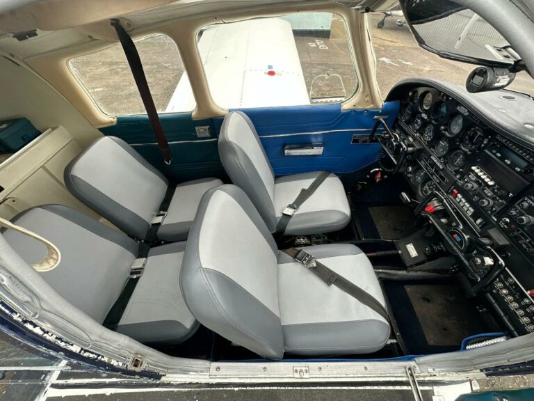 Interior view of a small aircraft cockpit with seats