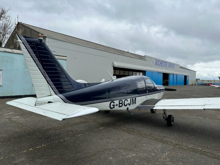 Small airplane parked at Rochester Airport
